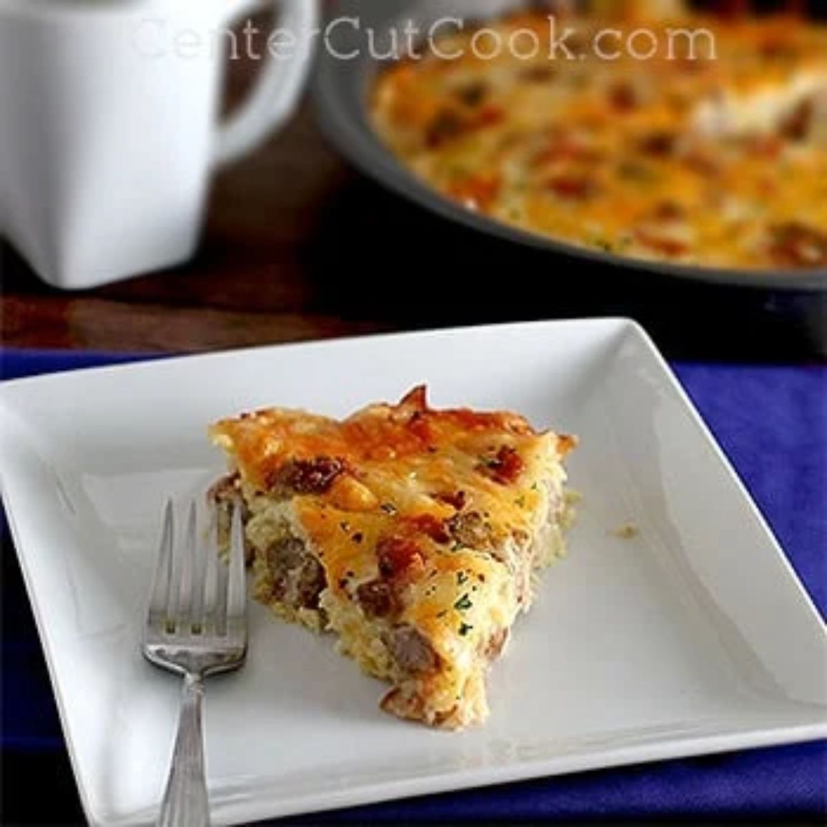 piece of amish breakfast casserole on a plate with a fork