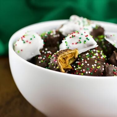 easy chocolate covered peanut butter pretzels topped with sprinkles in a bowl.