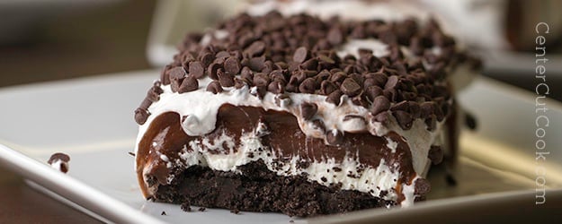 close-up of a bite of chocolate lasagna topped with mini chocolate chips, perfect for parties and special occasions