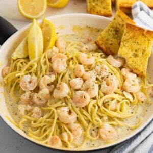 creamy shrimp scampi pasta in a pan with garlic, butter and juicy shrimp.