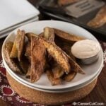 plate of crispy potato wedges with garlic dipping sauce