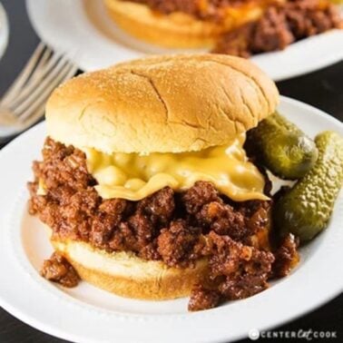 slow cooker sloppy joes with pickles on a plate