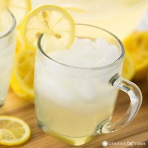 glass of perfect homemade lemonade with ice and a lemon slice