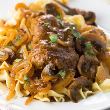 Salisbury steak with mushrooms and onions served with gravy.