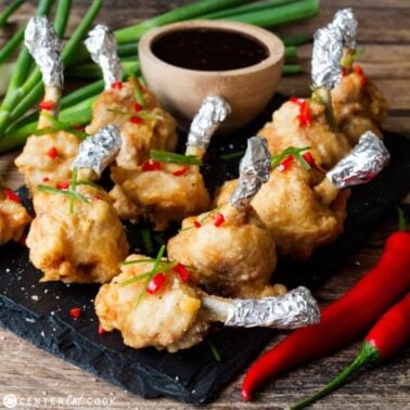 plate of chicken lollipops with dipping sauce