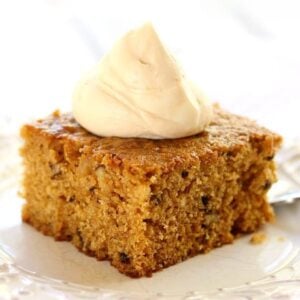 a slice of pumpkin walnut cake topped with homemade caramel whipped cream