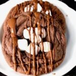 freshly baked hot chocolate cookies with marshmallows on a plate.