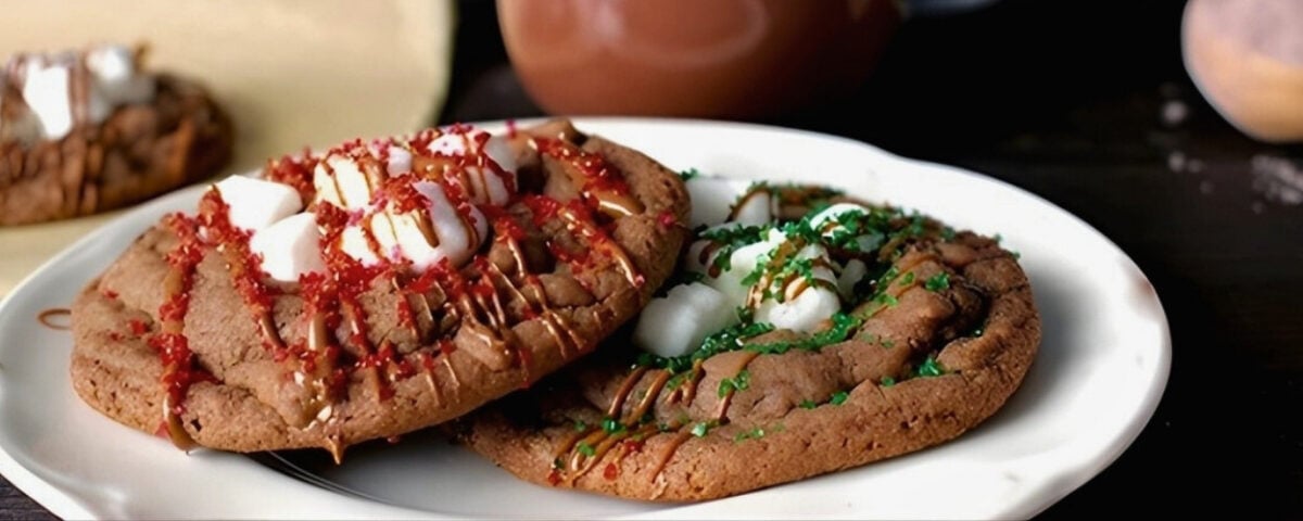 hot chocolate cookies drizzled with chocolate and topped with red and green sugar crystals for the perfect christmas cookie.