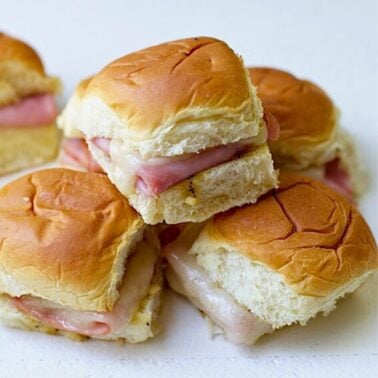 baked ham and cheese sliders made with Hawaiian Rolls, Swiss cheese and a buttery poppy seed sauce.