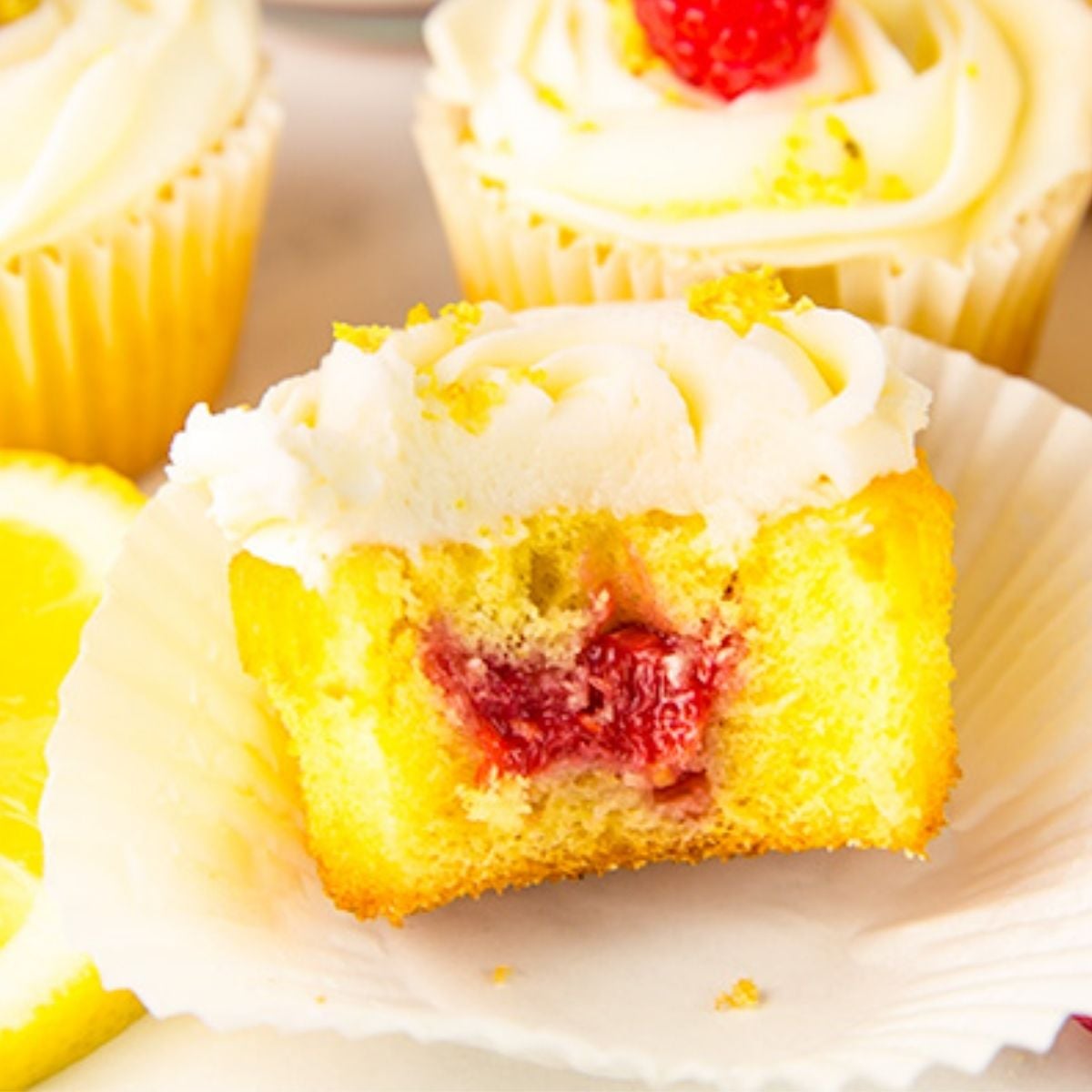 fluffy lemon cupcakes are filled with a sweet homemade raspberry filling and topped with a bright, creamy lemon buttercream for the perfect balance of tart and sweet in every bite.