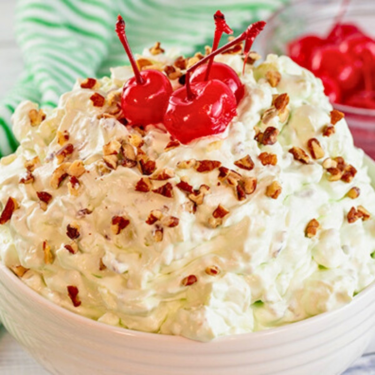 bowl of creamy Watergate salad made with pistachio pudding, pineapple, mini marshmallow and chopped pecans.