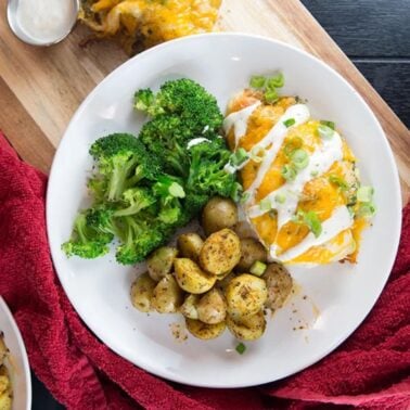 plate of baked ranch chicken with potatoes and broccoli