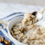 spoon of oatmeal pulling out of a bowl of oatmeal.