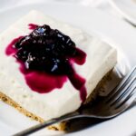 no bake cheesecake bar on a plate with a fork
