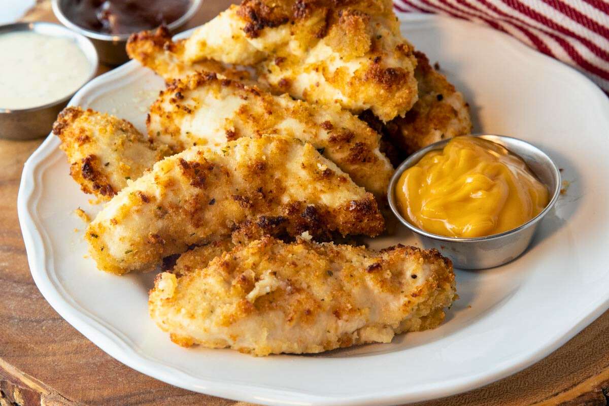 plate of air fryer parmesan crusted chicken with dipping sauce