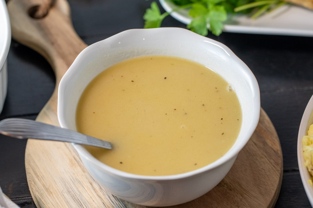 bowl of perfect turkey gravy with a ladle.