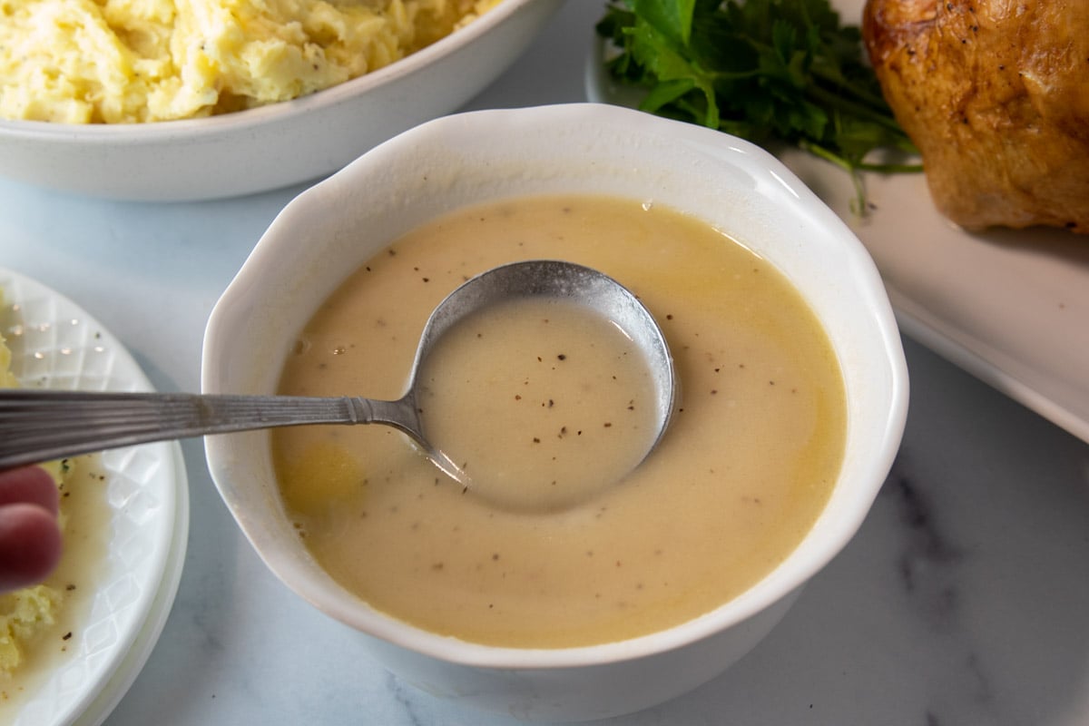 bowl of turkey gravy with a ladle