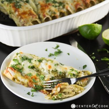 green chicken chile enchiladas on a plate with a fork