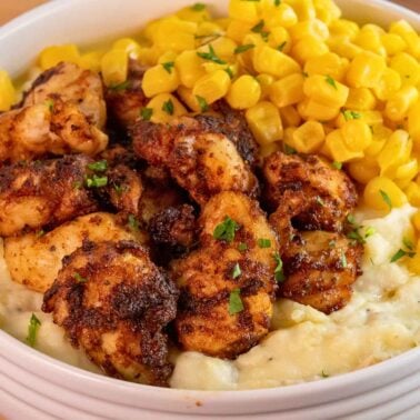 air fryer chicken bites without breading served in a bowl with mashed potatoes and corn