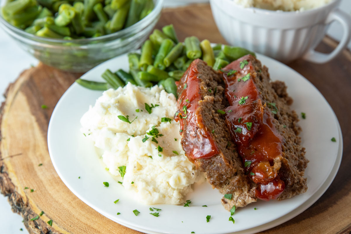 Lipton Onion Soup Meatloaf on a plate with mashed potatoes and green beans
