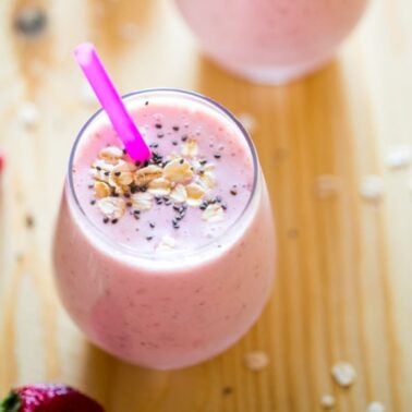 glass of Strawberry Oatmeal Breakfast Smoothie with a straw