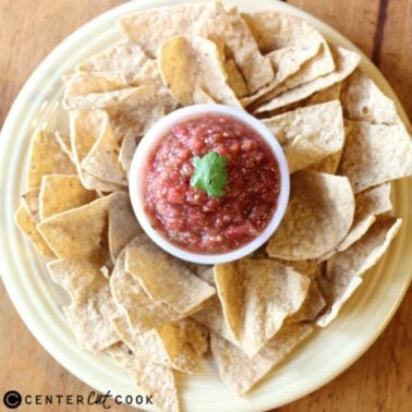 overhead of bowl of fresh homemade salsa surrounded by tortilla chips