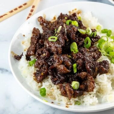 mongolian beef on a plate with rice