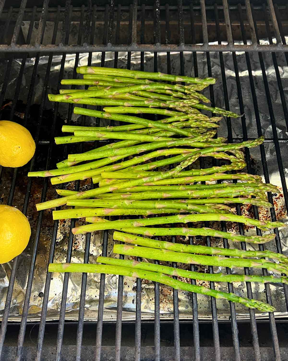 asparagus and lemon halves on a grill