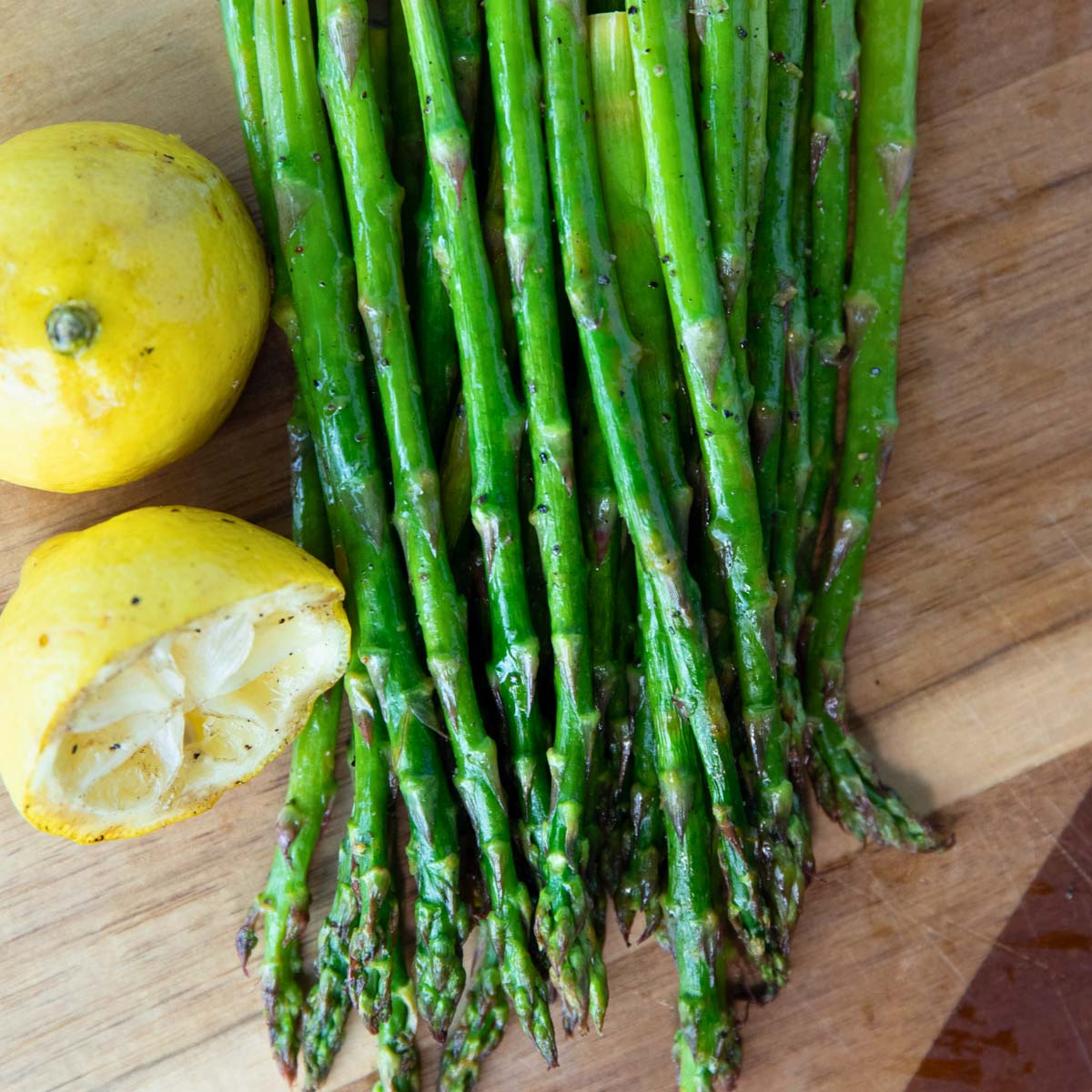 grilled asparagus with lemons sitting beside