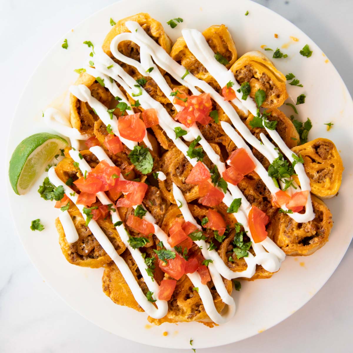 overhead of taco pinwheels on a plate