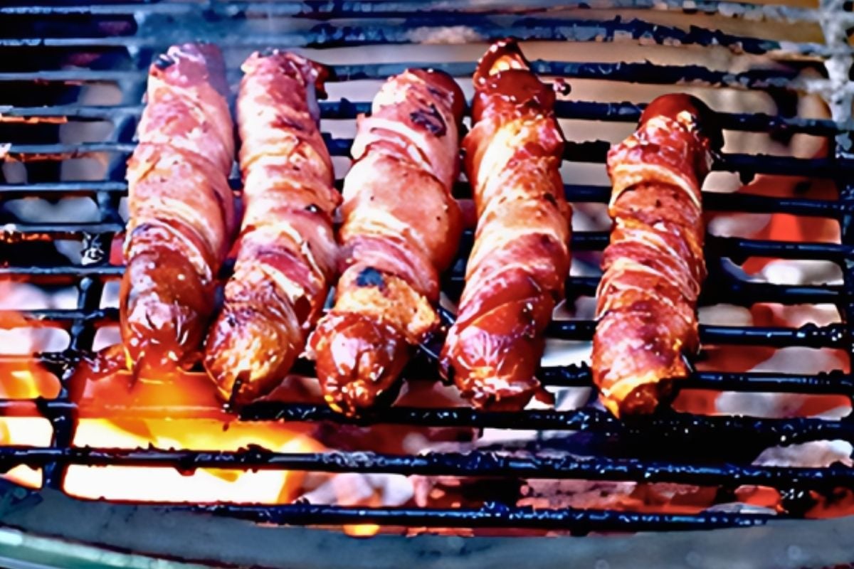 bacon wrapped hot dogs on the grill