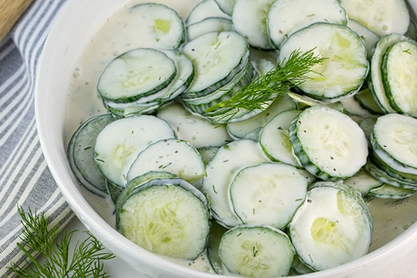 bowl of creamy cucumber salad with fresh dill