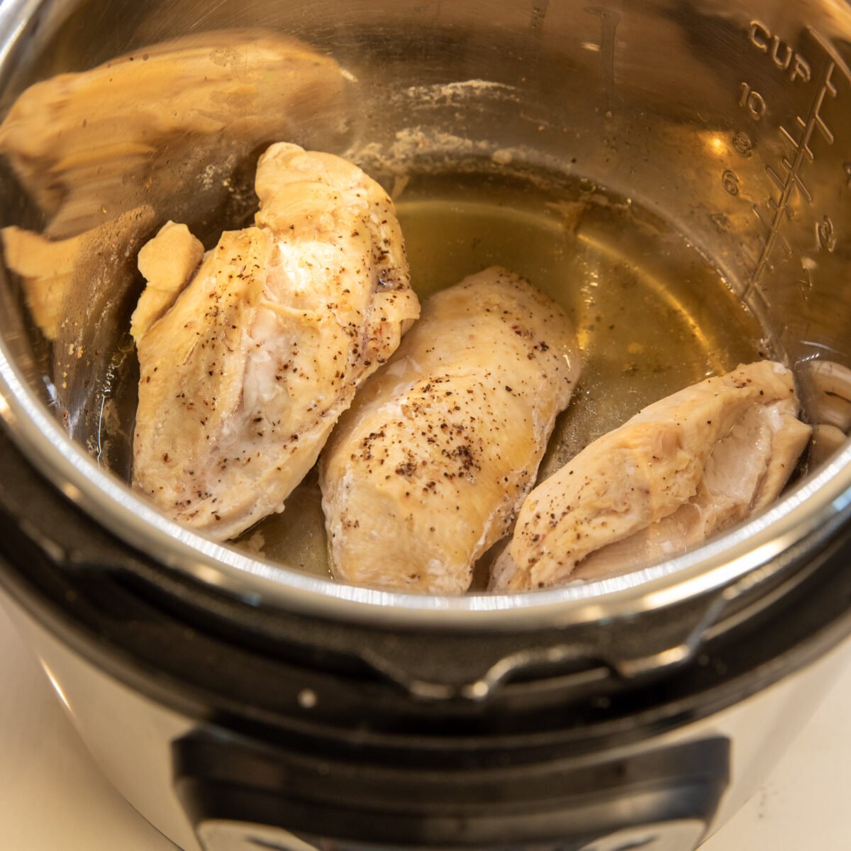 Freshly cooked chicken breasts in the Instant Pot, ready to be shredded or diced and served.