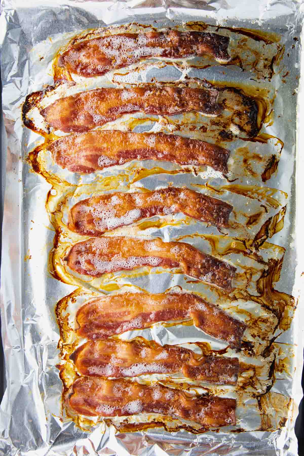 close-up of bacon cooking in the oven on a baking sheet