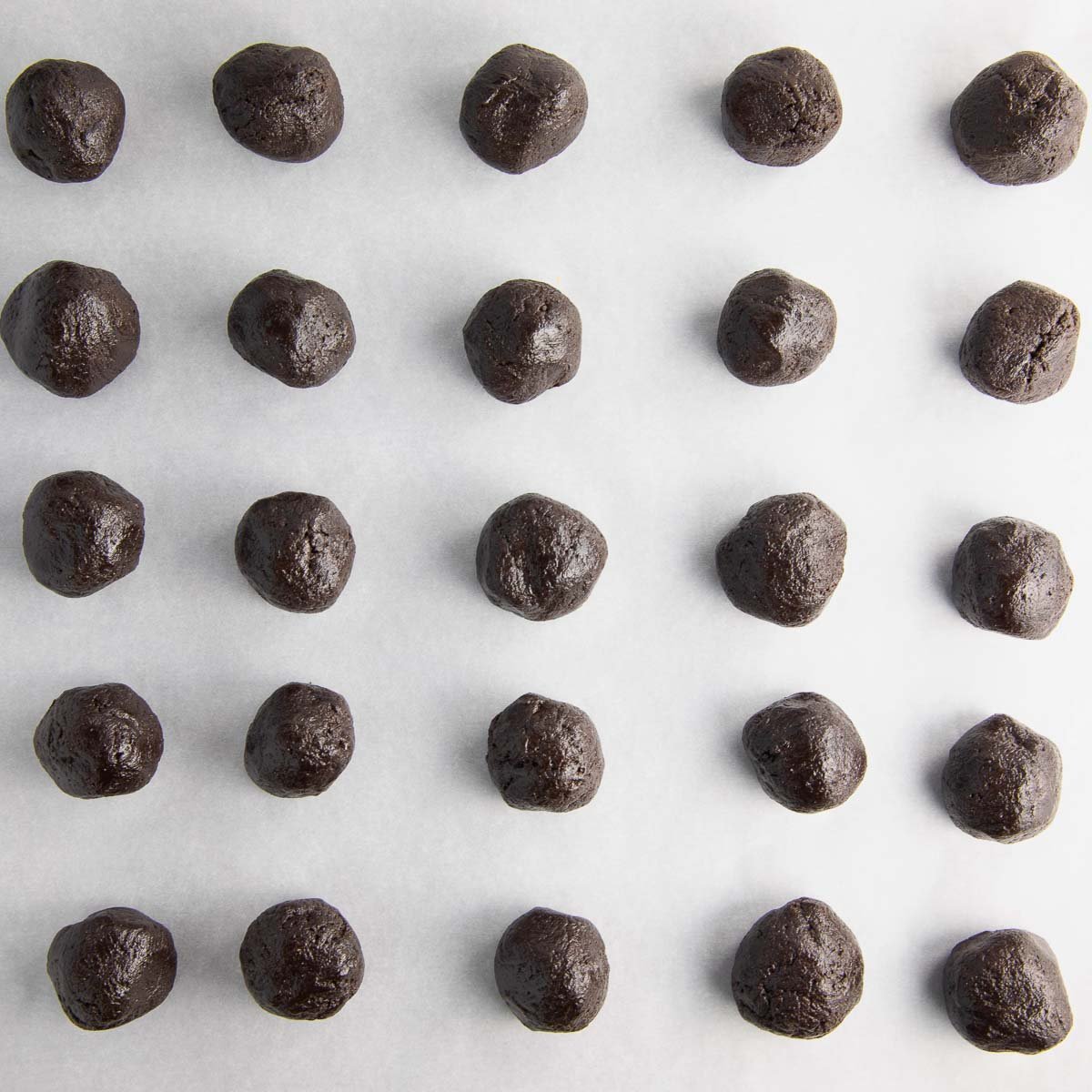 oreo balls on a parchment lined baking sheet
