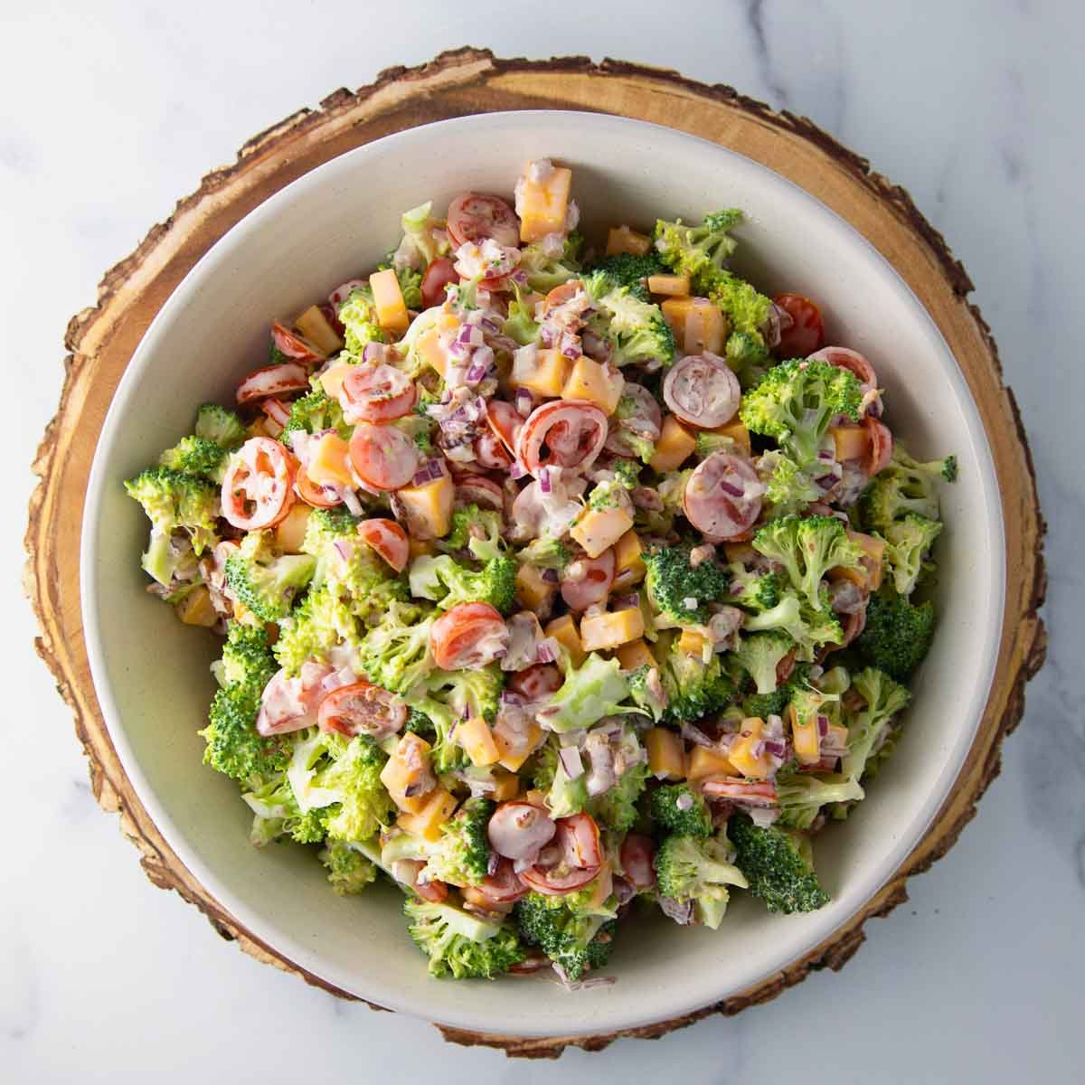 overhead bowl of broccoli salad tossed with a creamy mayo-based dressing