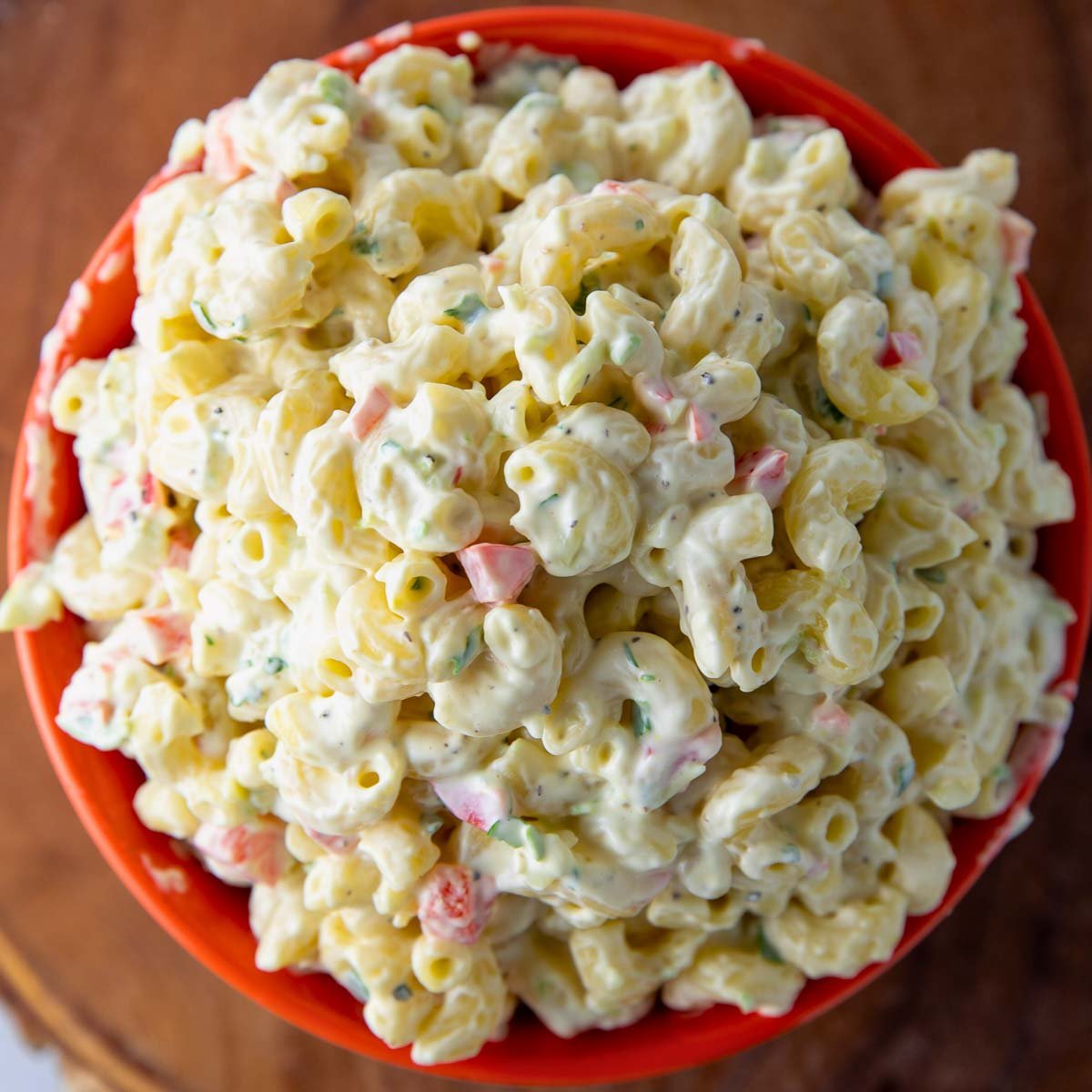 close-up of creamy homemade macaroni salad with vegetables