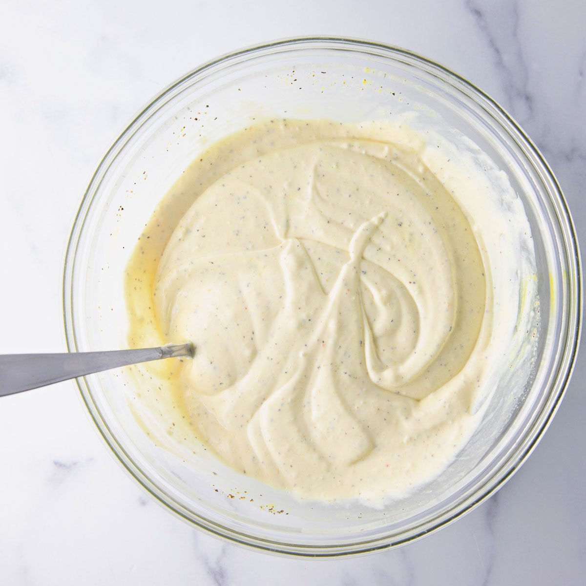 stirring macaroni salad ingredients together until well coated