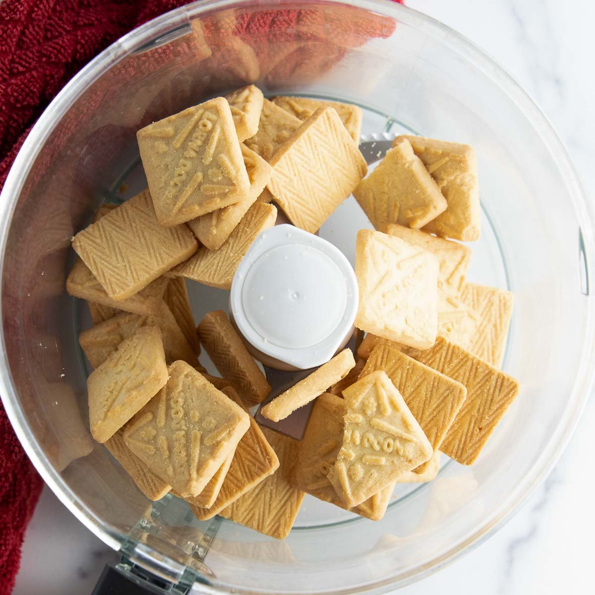 Crushing Lorna Doone cookies in a food processor for dessert crust.