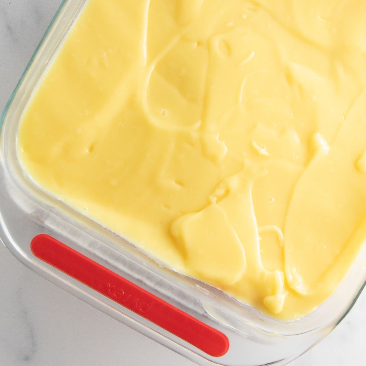 spreading the pudding layer over cheesecake layer