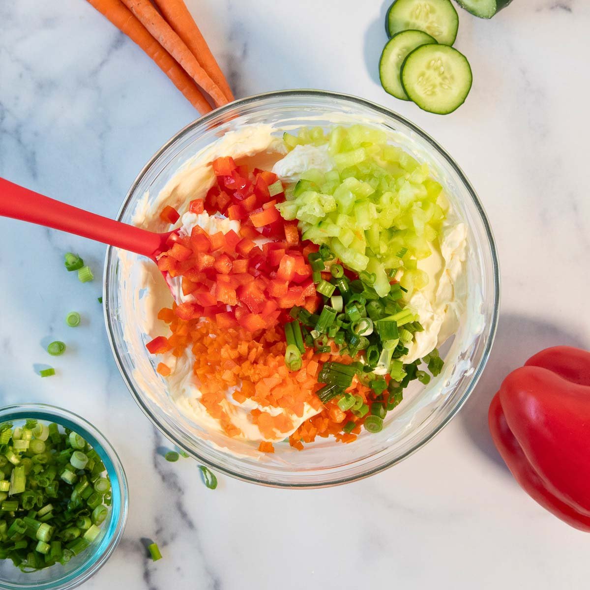 easy vegetable cream cheese recipe with carrots, bell peppers, cucumbers and green onions.