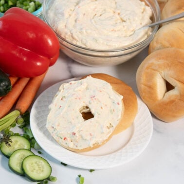 fresh homemade veggie cream cheese spread on a toasted bagel.