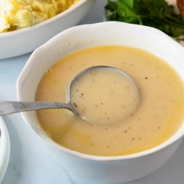 easy homemade chicken gravy in a white bowl ready to serve