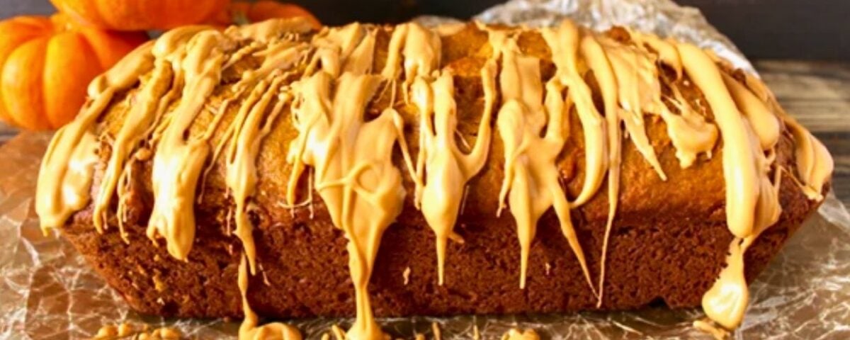loaf of pumpkin bread made with butterscotch pudding mix and drizzled with melted butterscotch chips