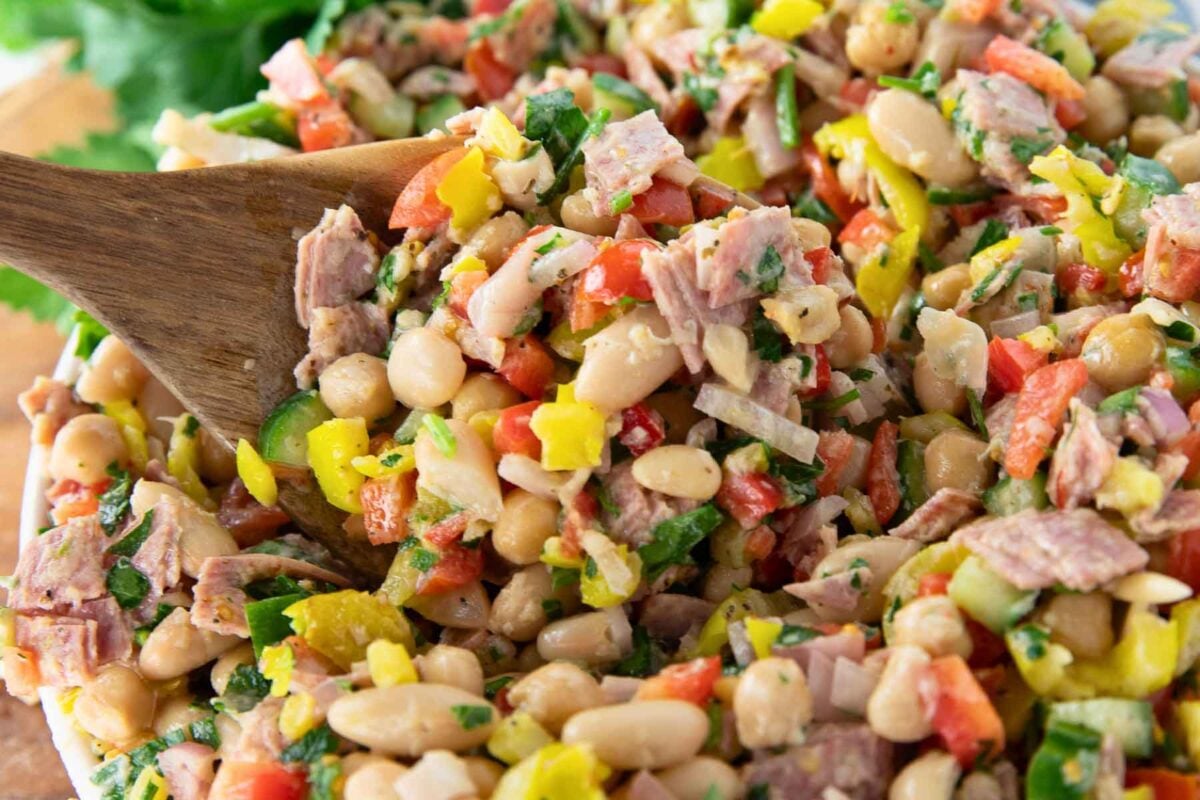 Italian dense bean salad with chickpeas, cannellini beans, salami and vegetables.